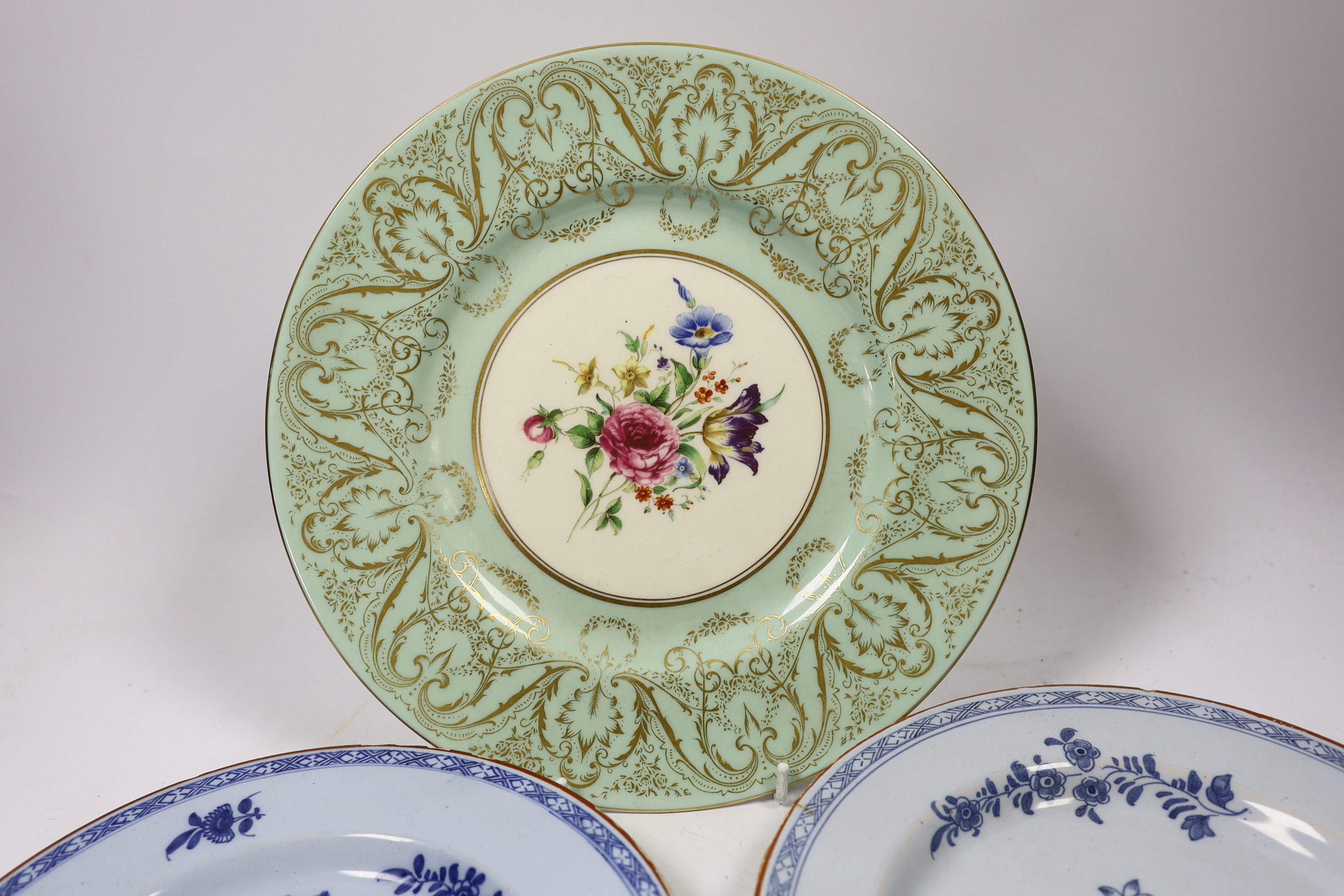 A pair of Delft plates, one dated 1771 and another Royal Worcester floral decorated plate, 27cm diameter